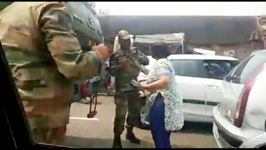 Woman holds Army Personnel's Collar